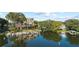 Waterfront condo building with boat docks and calm water, surrounded by mature trees and lush landscaping at 690 Osceola Ave # 502, Winter Park, FL 32789