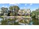 Amazing waterfront view featuring a boat dock, paddle boarders, kayaks, and the residential building in the background at 690 Osceola Ave # 502, Winter Park, FL 32789