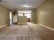 Spacious living room with neutral carpeting and a view into the kitchen at 7089 Balboa Dr # 7089, Orlando, FL 32818