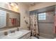 Well-lit bathroom with a shower-tub combo and a decorative vanity mirror at 735 Oak Ter, Orange City, FL 32763