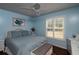 Charming bedroom featuring a wicker headboard, blue walls, and window shutters at 735 Oak Ter, Orange City, FL 32763
