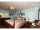 Spacious main bedroom features a ceiling fan, wooden furniture, and windows with a view to the outside at 735 Oak Ter, Orange City, FL 32763