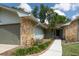 Close-up of the home's entrance highlighting the stone and well-maintained walkway and garden at 735 Oak Ter, Orange City, FL 32763