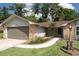 Beautifully landscaped front yard with stone accents and a walkway leading to the entrance of this charming home at 735 Oak Ter, Orange City, FL 32763