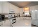 Well-lit kitchen with stainless steel appliances, a center island, and classic white cabinetry at 735 Oak Ter, Orange City, FL 32763