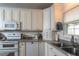 Updated kitchen featuring stainless steel appliances, light countertops, and ample cabinet space at 735 Oak Ter, Orange City, FL 32763