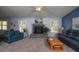 Spacious living room features a fireplace, plush seating, and bright windows with great natural light at 735 Oak Ter, Orange City, FL 32763