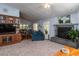 Open-concept living room flows to the dining area and features a fireplace and comfortable seating at 735 Oak Ter, Orange City, FL 32763