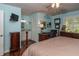 Bright main bedroom with ensuite bathroom, desk area, and windows allowing for great natural light at 735 Oak Ter, Orange City, FL 32763