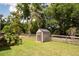 Outdoor shed with double doors, situated in a well-maintained grassy yard with trees at 735 Oak Ter, Orange City, FL 32763