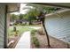 View along walkway towards the front of the house, highlighting the well-kept lawn and landscape at 735 Oak Ter, Orange City, FL 32763