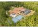 An expansive estate features a pool, tennis court, and a large home nestled in a lush, green landscape at 8590 Apache Trl, Kissimmee, FL 34747