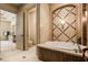 Beautiful bathroom featuring a soaking tub with decorative tile surround and elegant fixtures at 8590 Apache Trl, Kissimmee, FL 34747