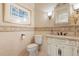 Charming powder room featuring decorative wall accents, ornate vanity, and stylish lighting at 8590 Apache Trl, Kissimmee, FL 34747