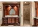 Lavish bathroom showcasing a custom vanity, stone countertop, and a decorative walk-in shower at 8590 Apache Trl, Kissimmee, FL 34747