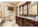 Lavish bathroom featuring a dual sink vanity with granite countertop and decorative cabinetry at 8590 Apache Trl, Kissimmee, FL 34747
