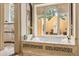 Luxurious bathtub with a private outdoor view, perfect for relaxation in a spa-like setting with natural light at 8590 Apache Trl, Kissimmee, FL 34747