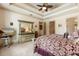 Large primary bedroom with coffered ceilings, ample natural light, and elegant furniture at 8590 Apache Trl, Kissimmee, FL 34747