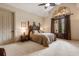 Spacious bedroom featuring a high ceiling, decorative doorway, and a door leading to the outside at 8590 Apache Trl, Kissimmee, FL 34747