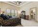 Beautiful bedroom showcasing large windows with shutters, a coffered ceiling, and closet access at 8590 Apache Trl, Kissimmee, FL 34747