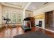 Workout area with hardwood floors, treadmill, telescope, and multiple arched windows offering scenic views at 8590 Apache Trl, Kissimmee, FL 34747