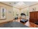Bright exercise room with vaulted ceilings, skylight, hardwood floors, and large windows with shutters at 8590 Apache Trl, Kissimmee, FL 34747