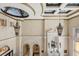 Grand foyer featuring high ceilings, custom lighting, and architectural details and marble floors at 8590 Apache Trl, Kissimmee, FL 34747