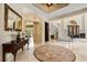 Grand foyer with marble floors, ornate staircase, and elegant furnishings create a luxurious entrance at 8590 Apache Trl, Kissimmee, FL 34747