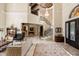 Spacious foyer features a grand staircase with iron railings, marble floors, and high ceilings with ornate details at 8590 Apache Trl, Kissimmee, FL 34747