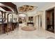 Spacious foyer with a wet bar, arched doorways, and marble flooring for an elegant entrance at 8590 Apache Trl, Kissimmee, FL 34747