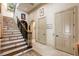 Elegant foyer featuring staircase with wood and marble steps, wrought iron railings, and marble tile flooring at 8590 Apache Trl, Kissimmee, FL 34747