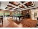 Entertainer's game room featuring a billiard table, hardwood floors, custom lighting, and sliding glass doors to a lanai at 8590 Apache Trl, Kissimmee, FL 34747