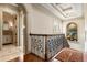 Elegant upstairs hallway with hardwood floors, decorative stair railing, and an arched display alcove at 8590 Apache Trl, Kissimmee, FL 34747