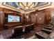 Luxurious home theater with comfortable seating, a large screen, and custom lighting for an immersive experience at 8590 Apache Trl, Kissimmee, FL 34747