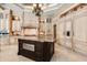 Bright kitchen featuring custom cabinets, stone backsplash, and island with granite countertop at 8590 Apache Trl, Kissimmee, FL 34747