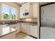 Bright laundry room features modern washer/dryer, granite countertop, and convenient storage cabinets at 8590 Apache Trl, Kissimmee, FL 34747