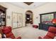 Elegant living room with french doors, built-in bookshelf, and arched entryway, perfect for relaxing and entertaining at 8590 Apache Trl, Kissimmee, FL 34747
