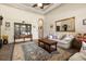 Inviting living room offers a decorative area rug, comfortable seating, and large mirror for an open feel at 8590 Apache Trl, Kissimmee, FL 34747