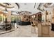 Open-concept living room features a coffered ceiling, built-in bookshelves, and a kitchen island with seating at 8590 Apache Trl, Kissimmee, FL 34747