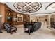 Bright living room features a custom ceiling, wooden built-ins, and tile flooring at 8590 Apache Trl, Kissimmee, FL 34747