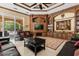 Spacious living room with custom wood built-ins, fireplace, and comfortable leather couches at 8590 Apache Trl, Kissimmee, FL 34747