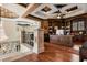 Home office with custom wood bookshelves, coffered ceilings, built-in desk, and a decorative wrought iron railing at 8590 Apache Trl, Kissimmee, FL 34747