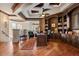 Spacious home office features custom built-in bookshelves, hardwood floors, and an elegant coffered ceiling at 8590 Apache Trl, Kissimmee, FL 34747