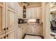 Butler's pantry with custom cabinets, granite countertops, and ample storage is ideal for organization at 8590 Apache Trl, Kissimmee, FL 34747