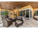 This inviting patio features comfortable seating, a ceiling fan, and direct access to indoor living spaces at 8590 Apache Trl, Kissimmee, FL 34747