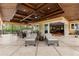 A covered patio features lounge seating, ceiling fans, and access to the home's interior through sliding glass doors at 8590 Apache Trl, Kissimmee, FL 34747