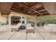 Inviting covered patio with wood ceiling, tile floors, and lounge seating with sliding door access to the interior at 8590 Apache Trl, Kissimmee, FL 34747