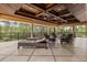 Inviting outdoor patio featuring a coffered wood ceiling, comfortable seating, and a scenic view at 8590 Apache Trl, Kissimmee, FL 34747