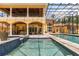 A sparkling pool and spa are enclosed, and adjacent to a covered patio area at 8590 Apache Trl, Kissimmee, FL 34747