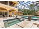 The enclosed pool area includes a hot tub and covered patio, perfect for relaxing and entertaining at 8590 Apache Trl, Kissimmee, FL 34747